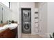Bathroom with stackable washer-dryer and built-in shelves at 530 N Mcdowell St, Charlotte, NC 28204