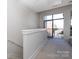 Hallway leading to bedroom with sliding glass doors leading to a balcony area at 530 N Mcdowell St, Charlotte, NC 28204