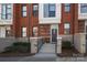 Charming brick townhome featuring concrete steps, an ADT security system, and inviting landscaping at 530 N Mcdowell St, Charlotte, NC 28204