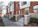Brick townhomes featuring concrete steps with black rails and well-maintained landscaping at 530 N Mcdowell St, Charlotte, NC 28204