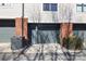 Exterior showing garage entrance with brick accents and landscaped shrubbery outside a townhome at 530 N Mcdowell St, Charlotte, NC 28204