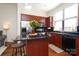 The kitchen boasts wood cabinets, stainless steel appliances, and a center island with seating at 530 N Mcdowell St, Charlotte, NC 28204