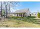 Backyard with trees, grass, and an outside patio at 6520 Fieldstone Manor Dr, Matthews, NC 28105