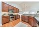 Well-equipped kitchen with granite countertops, stainless steel appliances, and wooden cabinets at 6520 Fieldstone Manor Dr, Matthews, NC 28105