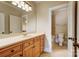 Well-lit bathroom featuring a large mirror, vanity with wooden cabinets, and toilet at 6548 Robin Hollow Dr, Mint Hill, NC 28227