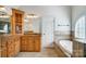 Bright bathroom featuring vanity, tub, and decorative tile at 6548 Robin Hollow Dr, Mint Hill, NC 28227