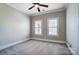 Neutral bedroom showcases a ceiling fan, soft carpet, and bright natural light at 6548 Robin Hollow Dr, Mint Hill, NC 28227