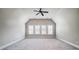 Bright bedroom features large windows, neutral walls, ceiling fan, and plush carpet at 6548 Robin Hollow Dr, Mint Hill, NC 28227
