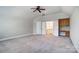 Neutral bedroom boasts carpet, a fan, and opens into a custom built-in workspace at 6548 Robin Hollow Dr, Mint Hill, NC 28227
