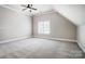 Bedroom features neutral walls, soft carpet, natural light, and a ceiling fan at 6548 Robin Hollow Dr, Mint Hill, NC 28227