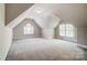 Attic bedroom features two windows and neutral colored walls and carpets at 6548 Robin Hollow Dr, Mint Hill, NC 28227