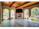 Inviting covered patio with stone flooring, wood ceilings, fireplace, and a TV for outdoor enjoyment at 6548 Robin Hollow Dr, Mint Hill, NC 28227