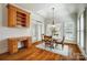 Bright dining area features hardwood floors, white shutters, and elegant chandelier at 6548 Robin Hollow Dr, Mint Hill, NC 28227