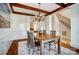 Formal dining room with wood beams, wainscoting, chandelier, and hardwood floors at 6548 Robin Hollow Dr, Mint Hill, NC 28227