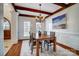 Bright dining room with hardwood floors, beamed ceiling, and wainscoting at 6548 Robin Hollow Dr, Mint Hill, NC 28227
