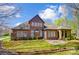 Charming brick home with lush landscaping, a manicured lawn, and well-maintained curb appeal on a sunny day at 6548 Robin Hollow Dr, Mint Hill, NC 28227