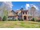 Charming two-story home with manicured lawn, brick facade and arched entryway at 6548 Robin Hollow Dr, Mint Hill, NC 28227