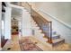 Inviting foyer featuring staircase with iron railing, tile flooring, and bright, open space at 6548 Robin Hollow Dr, Mint Hill, NC 28227