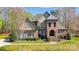 Charming two-story home with manicured lawn, brick facade and arched entryway at 6548 Robin Hollow Dr, Mint Hill, NC 28227