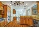 Open kitchen with granite countertops, wood cabinets, stainless steel appliances, and hardwood floors at 6548 Robin Hollow Dr, Mint Hill, NC 28227