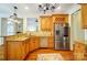 Well-equipped kitchen with stainless steel appliances, granite countertops, and wood cabinets at 6548 Robin Hollow Dr, Mint Hill, NC 28227