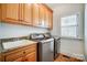 Convenient laundry room with modern appliances and built-in cabinets at 6548 Robin Hollow Dr, Mint Hill, NC 28227