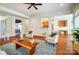 Open living room with hardwood floors, neutral decor, and a view to the kitchen at 6548 Robin Hollow Dr, Mint Hill, NC 28227