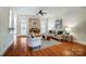 Bright living room with fireplace, arched windows, hardwood floors, and neutral decor at 6548 Robin Hollow Dr, Mint Hill, NC 28227