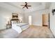 Large main bedroom featuring neutral carpet, tray ceiling, and ensuite access at 6548 Robin Hollow Dr, Mint Hill, NC 28227
