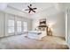 Spacious main bedroom with tray ceiling, ceiling fan, and serene decor at 6548 Robin Hollow Dr, Mint Hill, NC 28227