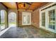 Cozy outdoor patio area with slate-look tile, brick walls, and a wood ceiling at 6548 Robin Hollow Dr, Mint Hill, NC 28227