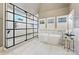 Luxurious bathroom featuring a stand-alone tub, frameless shower, and stylish fixtures at 700 Clement Ave, Charlotte, NC 28204