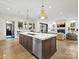 The kitchen showcases an island, stainless steel appliances, and a view of the living room at 700 Clement Ave, Charlotte, NC 28204