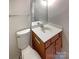 Cozy bathroom featuring a toilet, vanity with sink, mirror, and a light neutral color palette at 7829 Buddy Holly Rd, Charlotte, NC 28216