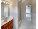 Bathroom featuring tile floors, glass shower, and dark wooden vanity at 7829 Buddy Holly Rd, Charlotte, NC 28216