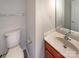 Cozy powder room with traditional vanity, white countertop and neutral walls at 7829 Buddy Holly Rd, Charlotte, NC 28216