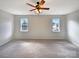 Bright bedroom with carpet flooring, neutral walls, and dual windows at 7829 Buddy Holly Rd, Charlotte, NC 28216