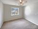 Bedroom with carpet floors, a large window, and neutral walls at 7829 Buddy Holly Rd, Charlotte, NC 28216