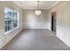 Traditional dining room with decorative chandelier, neutral walls, and carpet at 7829 Buddy Holly Rd, Charlotte, NC 28216