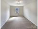 Carpeted room with great natural light and a window, perfect for an office or bedroom at 7829 Buddy Holly Rd, Charlotte, NC 28216