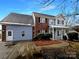 Charming home featuring a mix of brick and siding, complemented by mature landscaping at 7829 Buddy Holly Rd, Charlotte, NC 28216