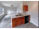 Functional kitchen with peninsula, stainless steel sink, and dark cabinets at 7829 Buddy Holly Rd, Charlotte, NC 28216