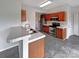 Functional kitchen featuring tile flooring, stainless steel appliances, and ample cabinet space at 7829 Buddy Holly Rd, Charlotte, NC 28216