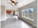 Open concept living space with large window, tile floors, and adjacent kitchen at 7829 Buddy Holly Rd, Charlotte, NC 28216