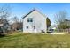 Spacious backyard with lush green grass, small concrete porch, and minimal landscaping at 81 Kirk St, Salisbury, NC 28144