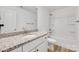 Bright bathroom featuring granite countertop, white vanity, and tub with shower at 81 Kirk St, Salisbury, NC 28144