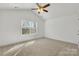 Bedroom with neutral carpet, large window, and ceiling fan at 81 Kirk St, Salisbury, NC 28144