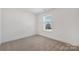 Bright bedroom with neutral carpet, white walls and window with natural light at 81 Kirk St, Salisbury, NC 28144