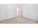 Neutral carpeted bedroom featuring white walls and a spacious closet at 81 Kirk St, Salisbury, NC 28144