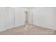 Neutral carpeted bedroom featuring white walls and a spacious closet at 81 Kirk St, Salisbury, NC 28144